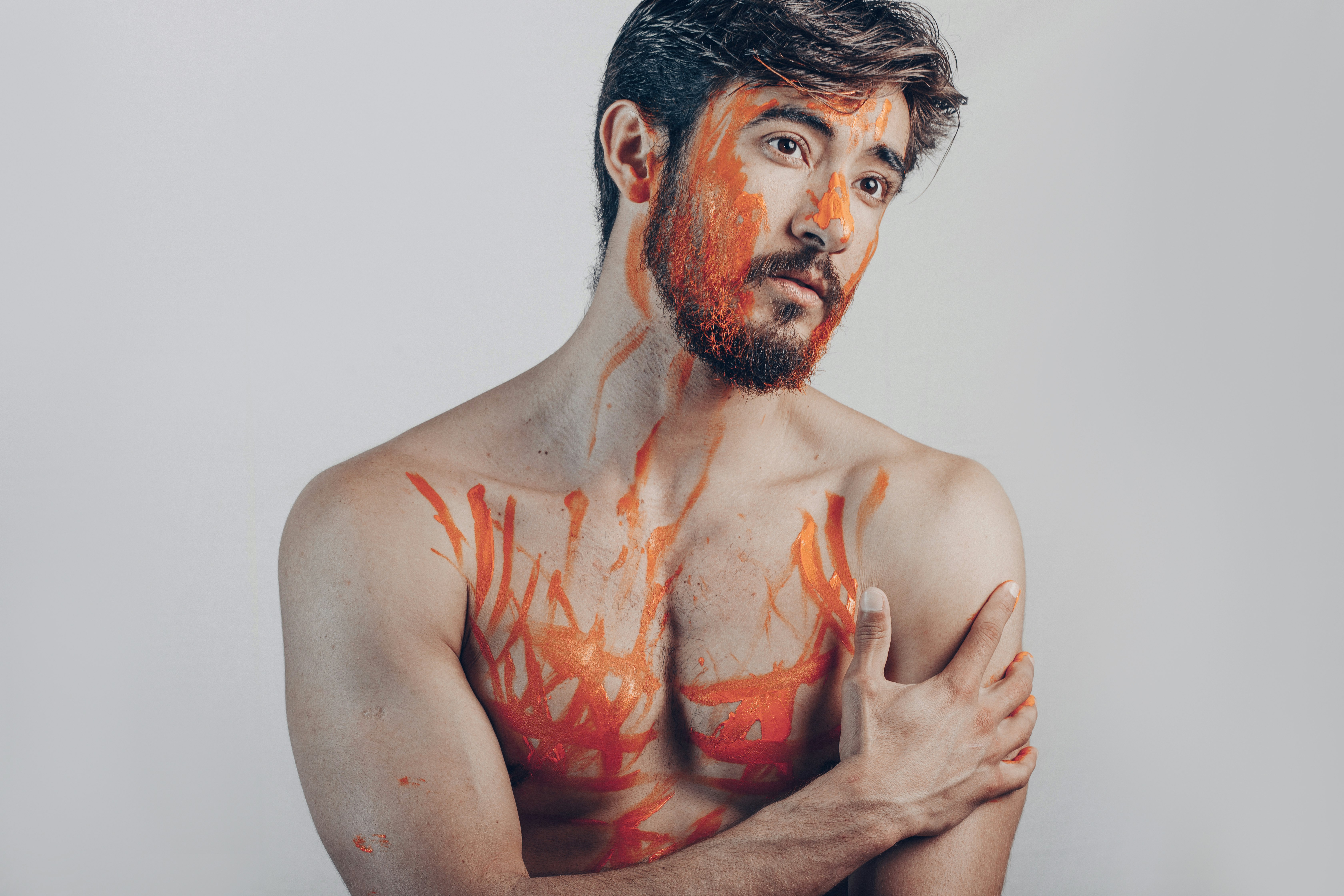 topless man with red paint on his face